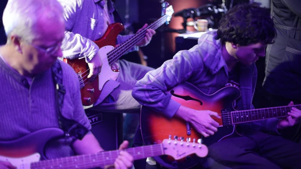 Students playing guitars
